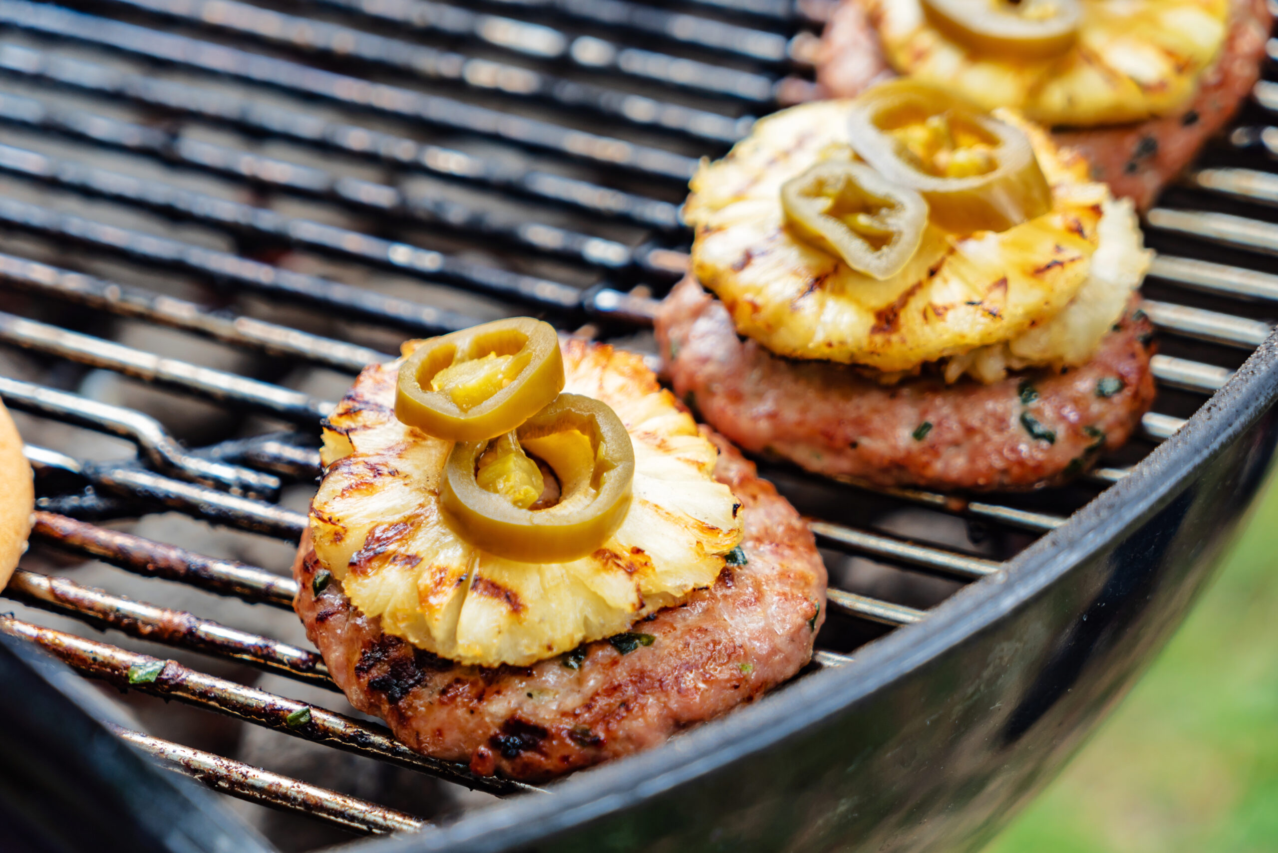 grilled Asian pork burger topped with pineapple slice and jalapeno rings