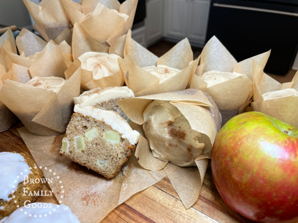 Salted Caramel Apple Spice Cupcakes in tulip liners with a visible cross-section.